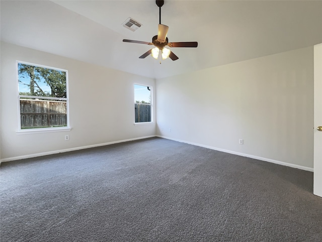 carpeted empty room featuring a wealth of natural light and ceiling fan