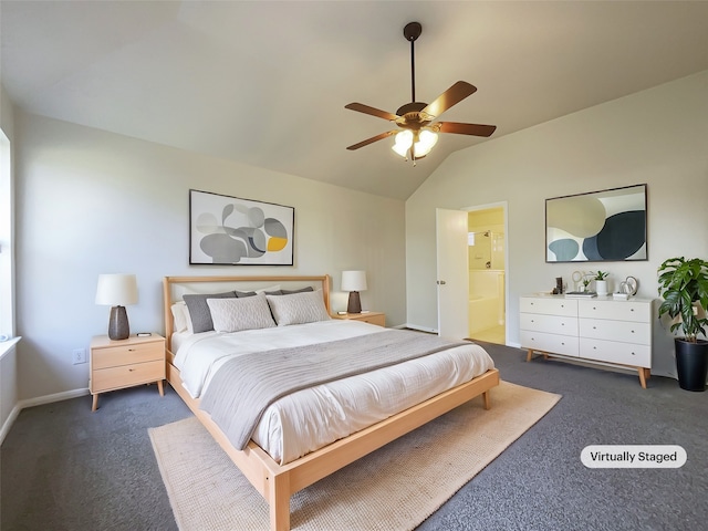 bedroom with ceiling fan, dark carpet, ensuite bathroom, and vaulted ceiling