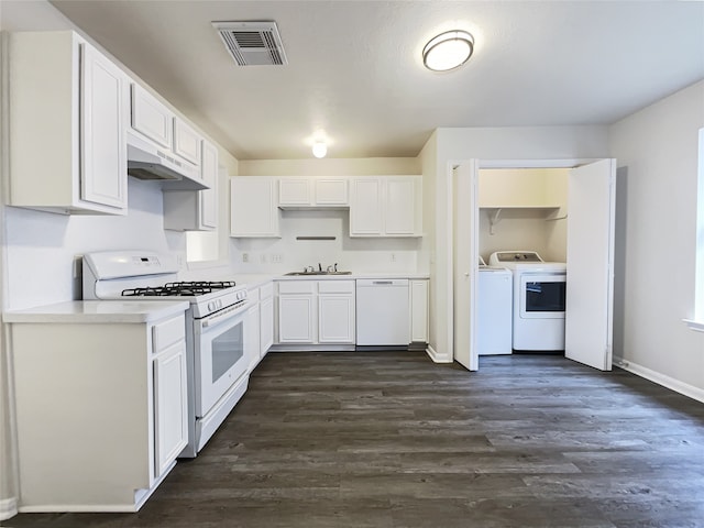 kitchen featuring washer and dryer, white appliances, white cabinetry, and dark wood-type flooring