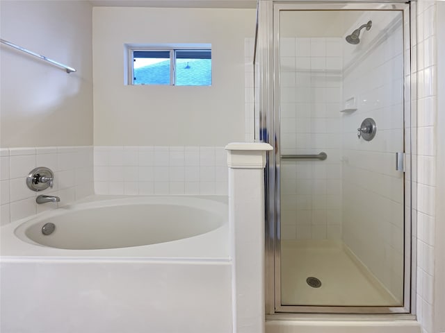 bathroom with separate shower and tub