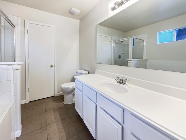 bathroom featuring tile patterned flooring, vanity, toilet, and an enclosed shower