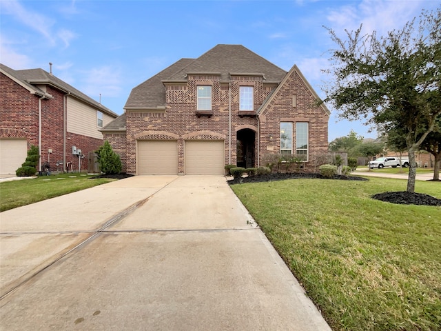 view of front of property featuring a front yard and a garage