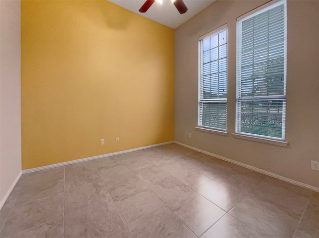 unfurnished room featuring ceiling fan and light tile patterned floors