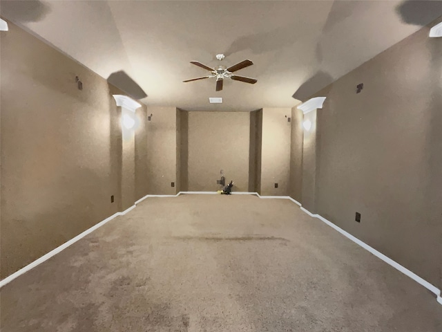 carpeted empty room with vaulted ceiling and ceiling fan