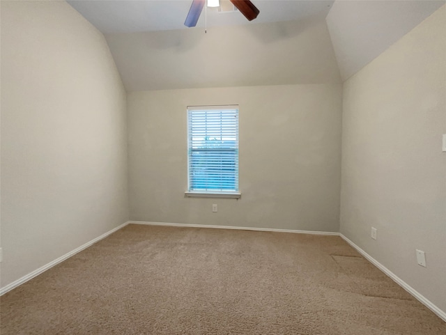 unfurnished room with ceiling fan, carpet floors, and vaulted ceiling