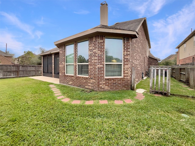 back of property featuring a yard