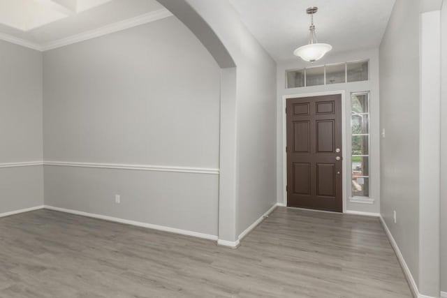 foyer featuring light hardwood / wood-style floors and ornamental molding