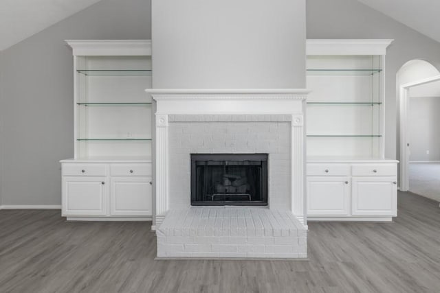 interior details with a brick fireplace and hardwood / wood-style floors