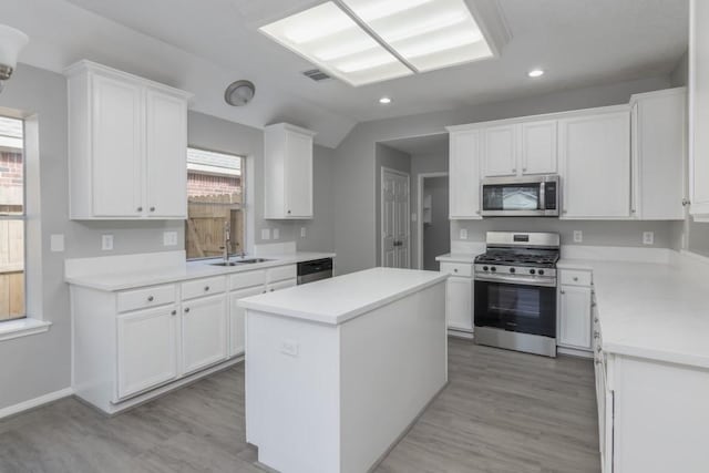 kitchen featuring white cabinetry, appliances with stainless steel finishes, and a center island