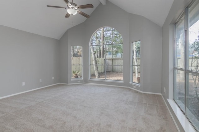 unfurnished room featuring ceiling fan, plenty of natural light, high vaulted ceiling, and light carpet