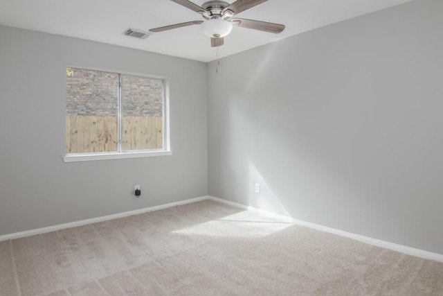 unfurnished room with ceiling fan and light colored carpet