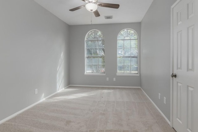 unfurnished room featuring light carpet and ceiling fan