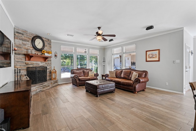 living room with ceiling fan, a fireplace, light hardwood / wood-style floors, and ornamental molding