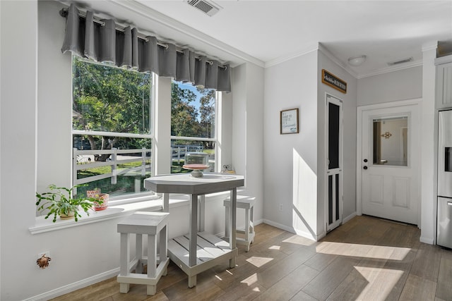 dining area with visible vents, plenty of natural light, and wood finished floors