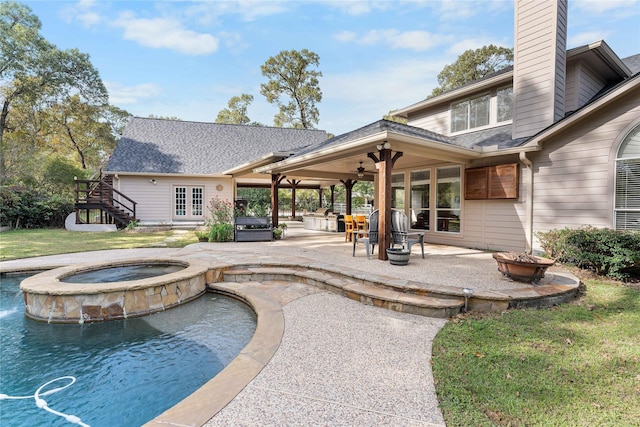 exterior space with a ceiling fan, a patio, a chimney, roof with shingles, and stairs