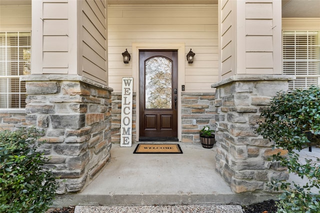 property entrance featuring stone siding