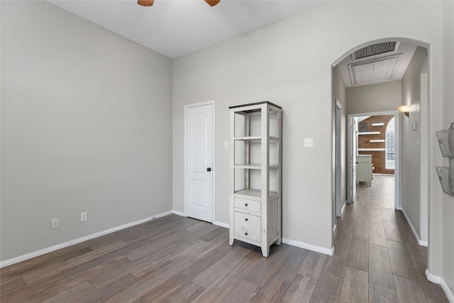 unfurnished bedroom featuring dark hardwood / wood-style flooring and ceiling fan