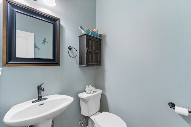 bathroom with toilet and a sink