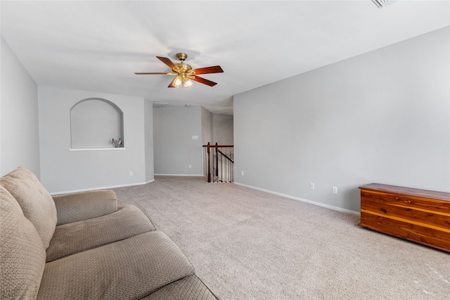 living area with carpet floors, ceiling fan, and baseboards