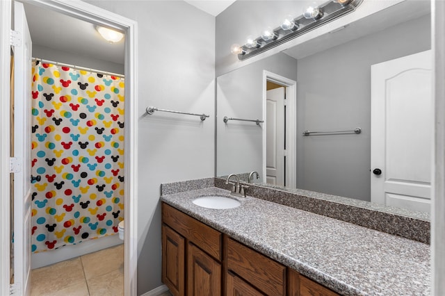 bathroom featuring toilet, tile patterned flooring, and vanity