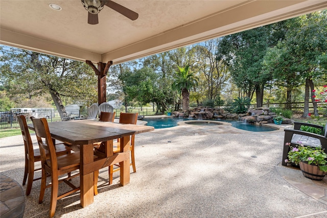 view of patio with a fenced backyard, an in ground hot tub, a ceiling fan, a fenced in pool, and outdoor dining space