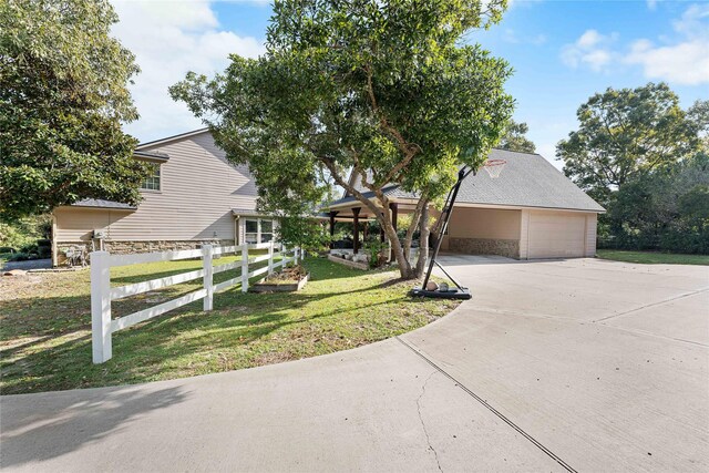 view of front of home featuring a garage and a front lawn