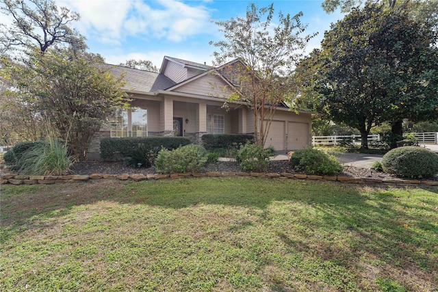 view of front of home featuring a front yard and a garage