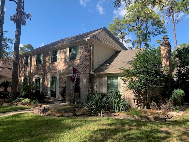 colonial-style house with a front yard