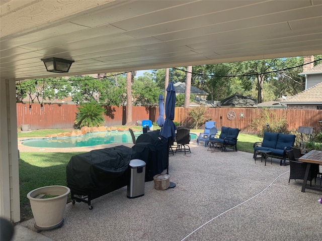 view of patio featuring a fenced in pool and an outdoor living space