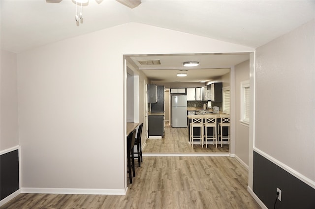 interior space with lofted ceiling and light wood-type flooring