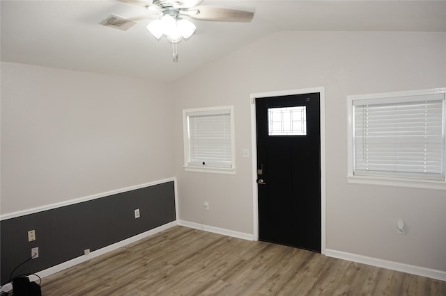 entryway with ceiling fan, vaulted ceiling, and hardwood / wood-style flooring