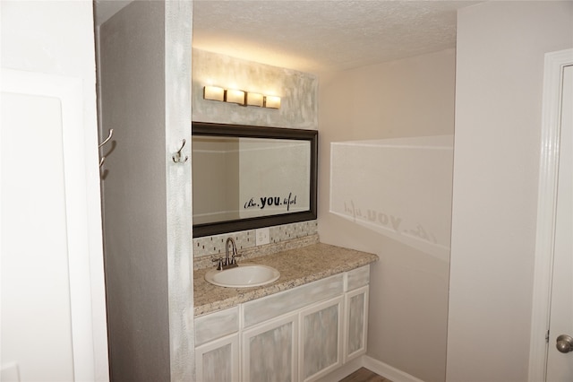 bathroom featuring vanity and a textured ceiling