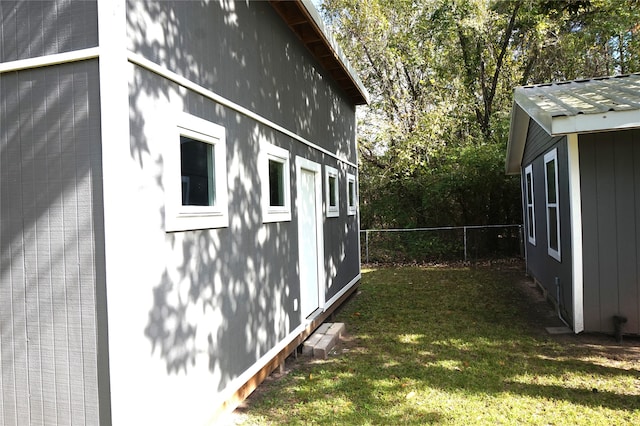 view of side of home featuring a yard