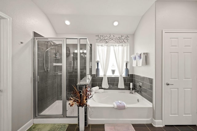 bathroom with independent shower and bath and lofted ceiling