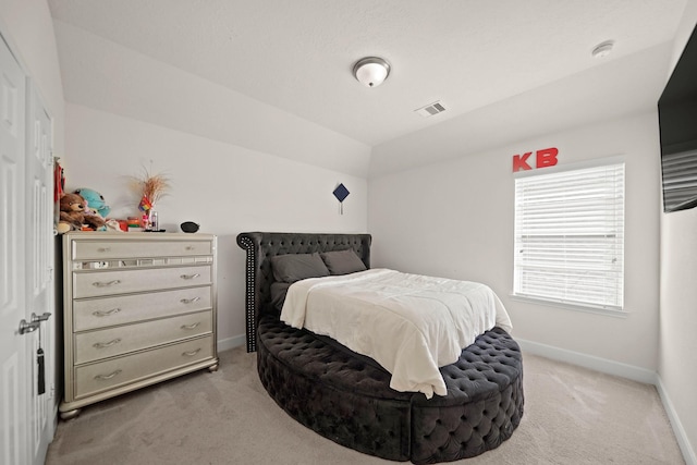 bedroom with light carpet and vaulted ceiling