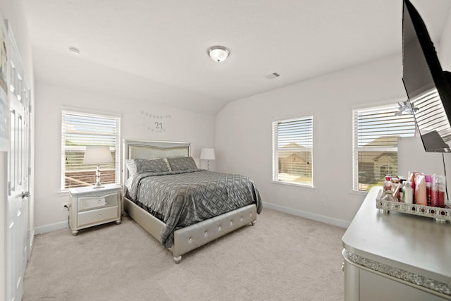 carpeted bedroom with lofted ceiling