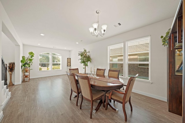 dining room featuring hardwood / wood-style floors and a notable chandelier