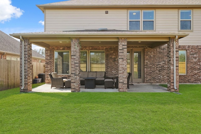 rear view of property with an outdoor living space, a patio area, and a yard