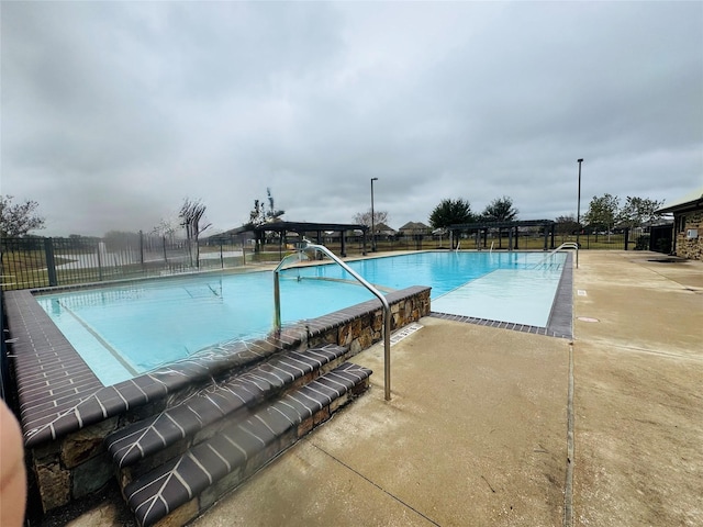 view of swimming pool with a patio area