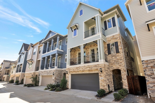 townhome / multi-family property featuring a balcony and a garage