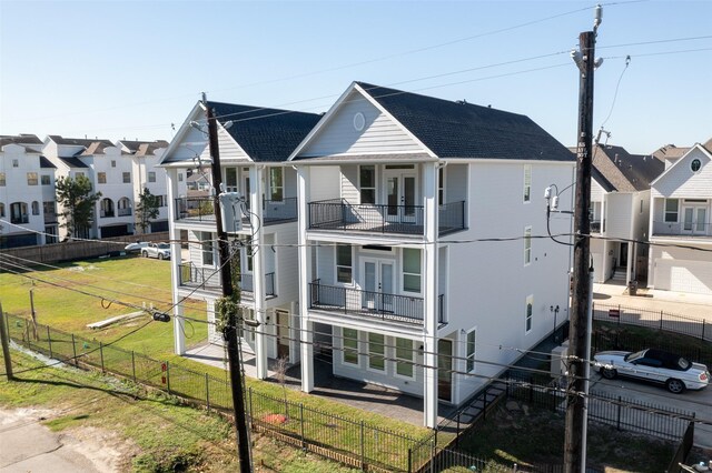 view of front of home featuring french doors and a front lawn