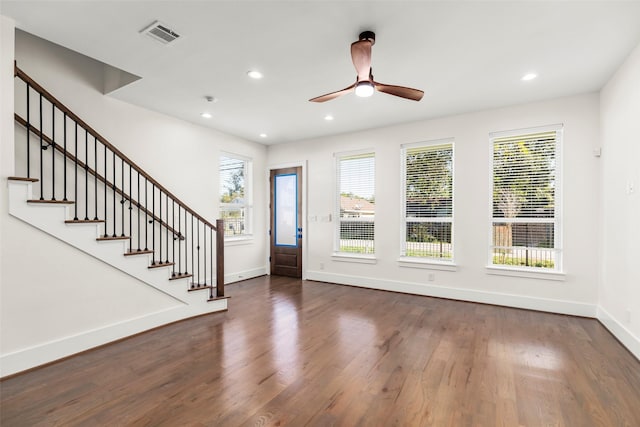 entrance foyer with a wealth of natural light, dark hardwood / wood-style flooring, and ceiling fan