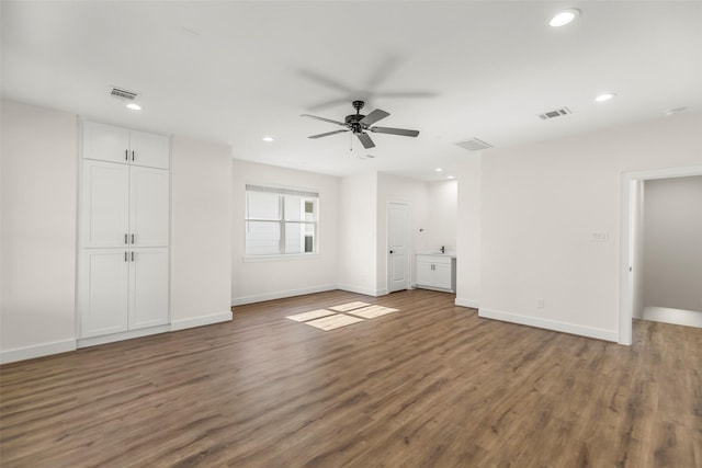 unfurnished living room with ceiling fan and dark hardwood / wood-style flooring