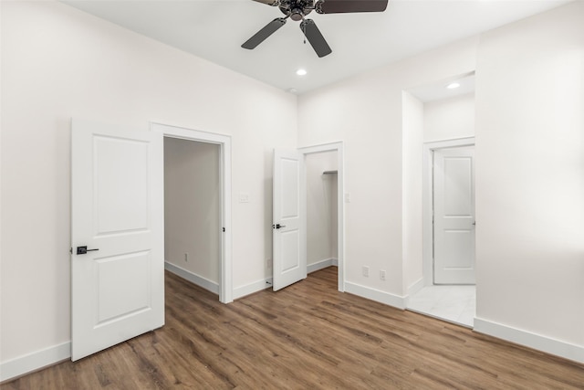 unfurnished bedroom featuring hardwood / wood-style flooring and ceiling fan