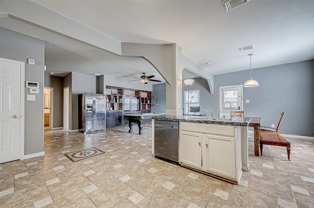 kitchen with dark stone counters, stainless steel appliances, ceiling fan, pendant lighting, and white cabinetry