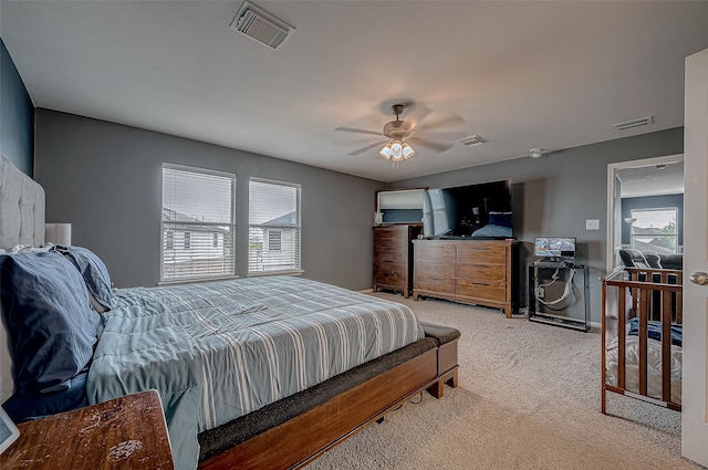 bedroom with ceiling fan and light carpet