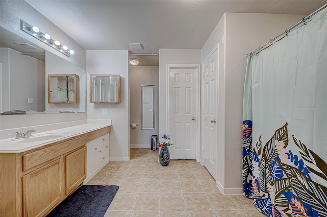 bathroom with tile patterned floors, vanity, and a shower with curtain