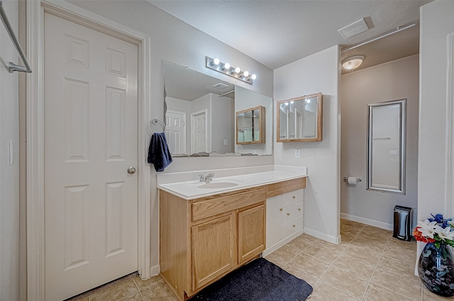 bathroom with vanity and tile patterned floors