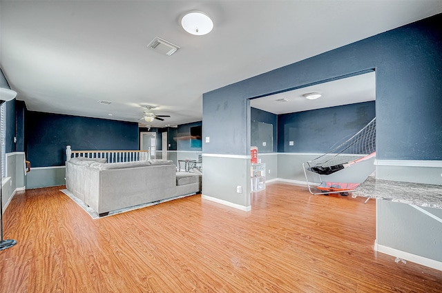 unfurnished living room with ceiling fan and light hardwood / wood-style floors