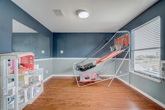 game room with wood-type flooring